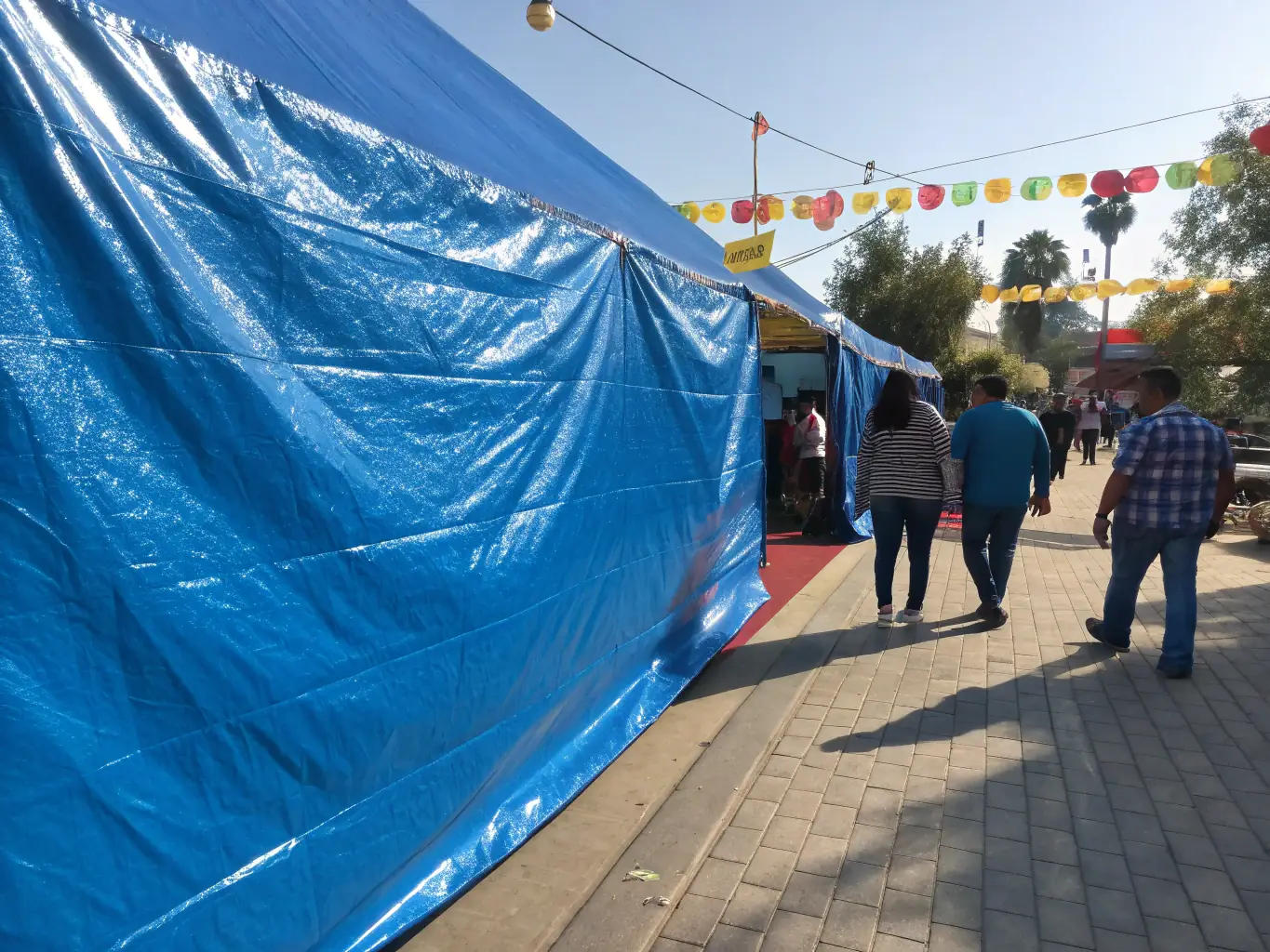 A vibrant image showcasing different sizes and colors of waterproof tarpaulins rolled out in an outdoor setting, highlighting their durability and versatility for various applications.